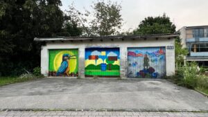 U27 Streetart-Stipendium Landsberg am Lech 2024: drei bunt gestaltete Garagentore in Schondorf neben der Realschule